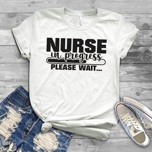 “Nurse in Progress – Please Wait” Graphic T-Shirt – White